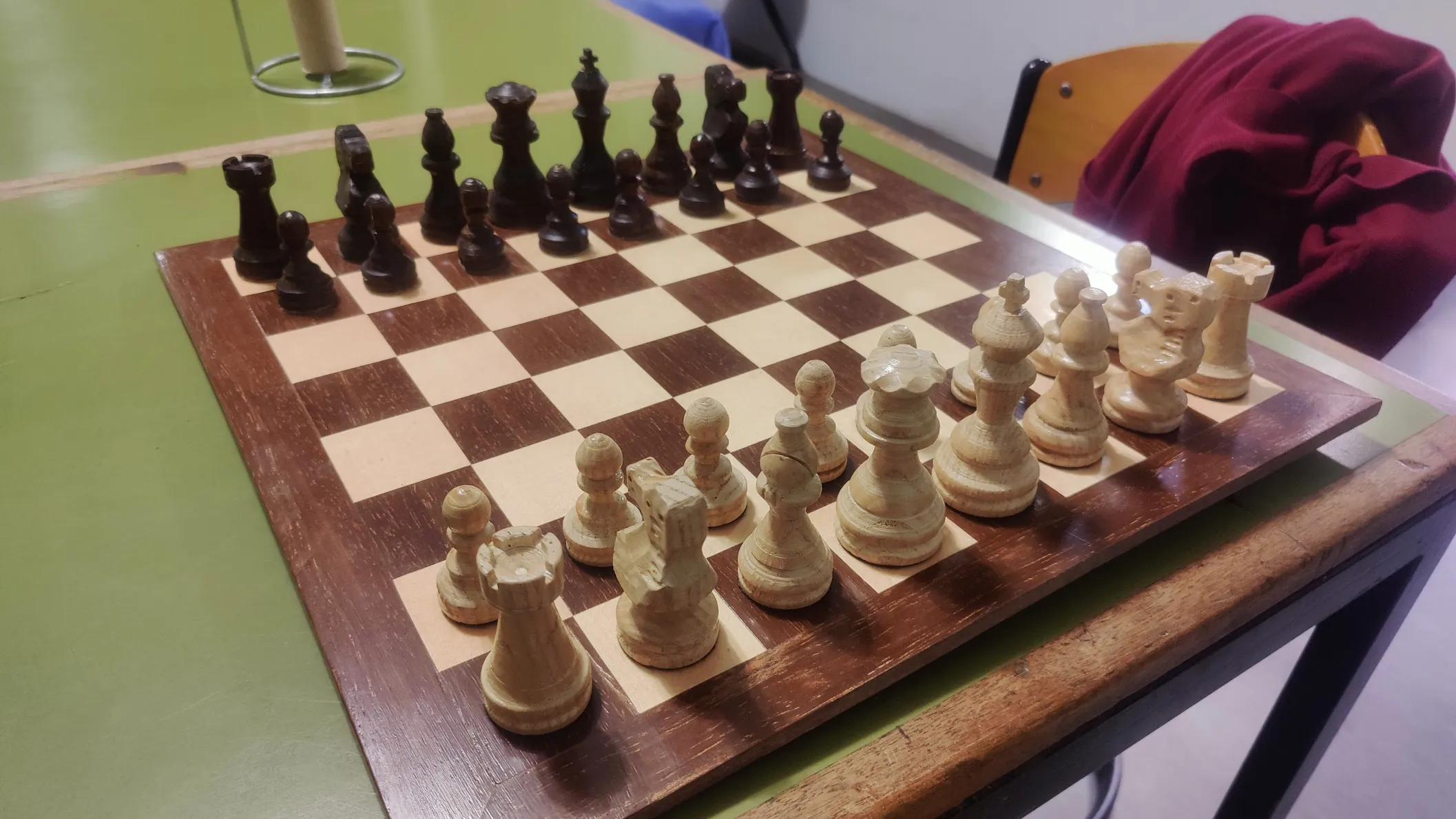The laminated wooden chess board with lathe-turned pieces